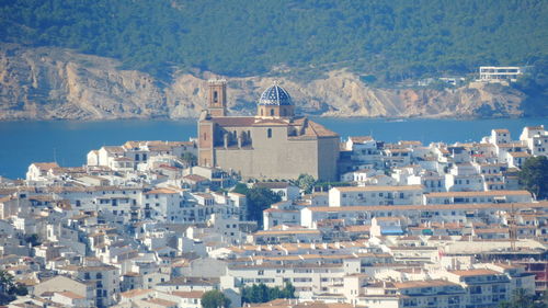 High angle view of townscape by sea