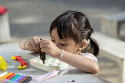 Close-up of cute girl with clay