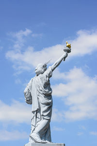 Low angle view of statue against sky