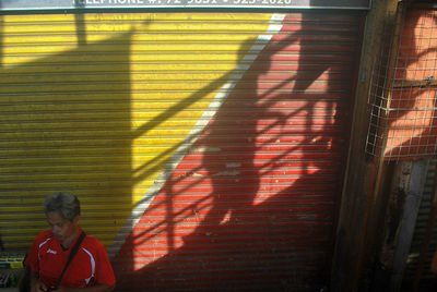 Shadow of man on red wall