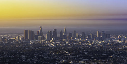 Aerial view of city buildings during sunset