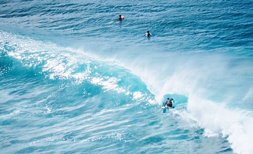 People surfing in sea