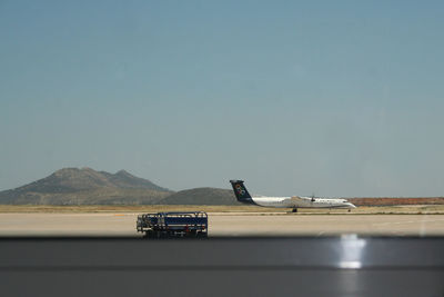 Airplane on runway against sky