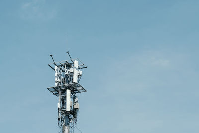 Low angle view of communications tower against sky