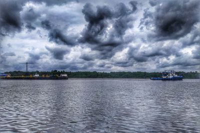 Scenic view of sea against storm clouds