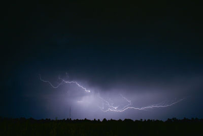 Low angle view of lightning in sky at night