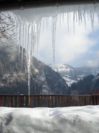 Scenic view of snow covered mountains against sky