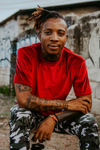 Portrait of man sitting outdoors