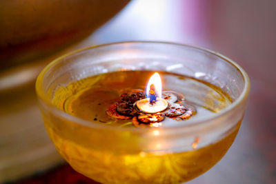 High angle view of lit candle on table