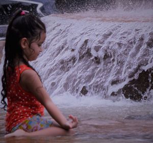 Side view of girl in water
