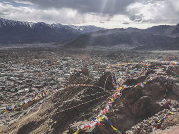 High angle view of buildings against cloudy sky