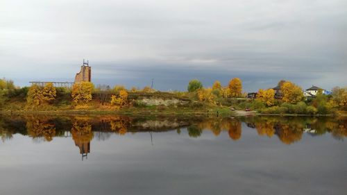 Reflection of trees on lake against sky during autumn