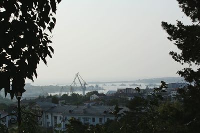 Town by sea against clear sky