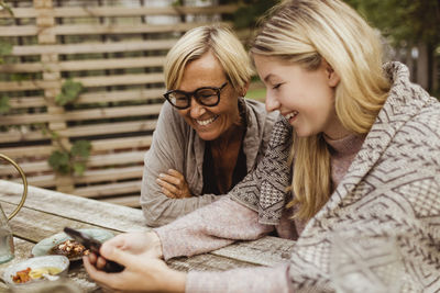 Smiling woman sitting outdoors