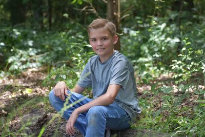 Portrait of smiling boy sitting outdoors