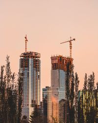 Modern buildings against clear sky during sunset