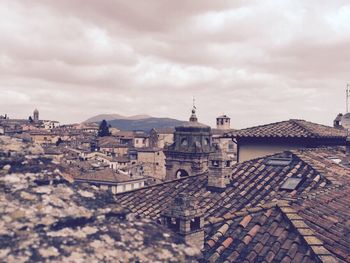 Buildings against cloudy sky