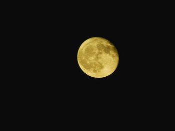 Low angle view of moon against clear sky at night