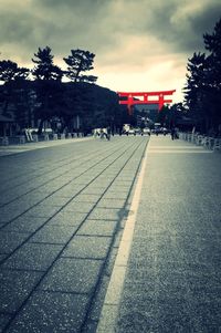 Empty road against cloudy sky