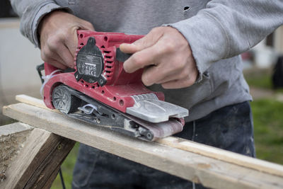 Midsection of man working in workshop