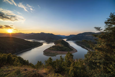 Scenic view of lake against sky during sunset