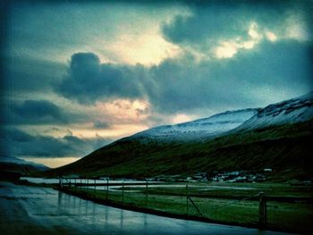 Scenic view of mountains against cloudy sky