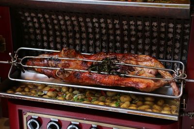 High angle view of meat grilled over prepared potatoes