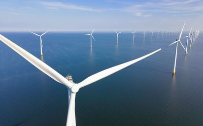 Low angle view of windmill against sky