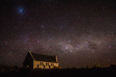 Low angle view of illuminated building against sky at night