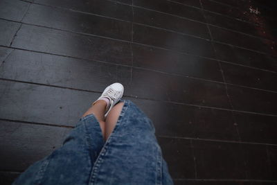 Low section of woman standing on tiled floor