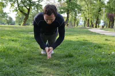 Full length of man performing yoga in park