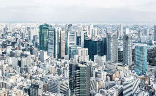 High angle view of modern buildings in city against sky