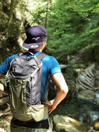 Rear view of a man standing in forest