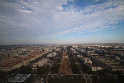 High angle view of cityscape against cloudy sky