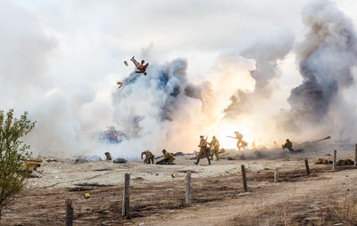 Panoramic view of people on land against sky