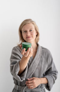 Portrait of young woman drinking coffee