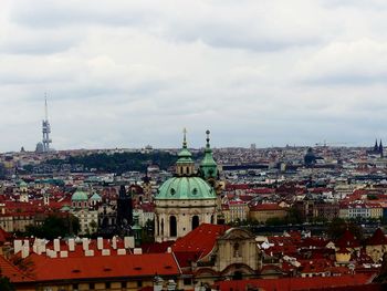 View of cityscape against cloudy sky