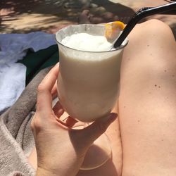 Close-up of hand holding drink outdoors