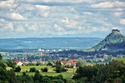 Scenic view of landscape and buildings against sky