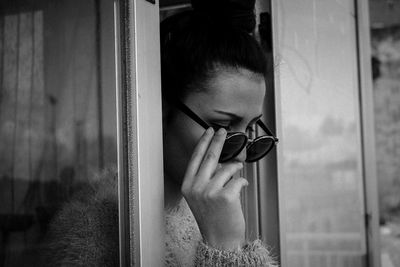 Close-up of woman wearing sunglasses looking down