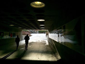 People standing in illuminated corridor
