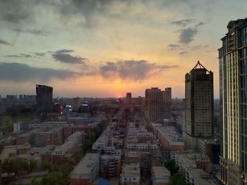 High angle view of buildings against sky during sunset