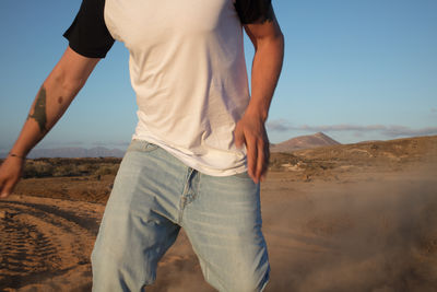 Midsection of man standing on desert land