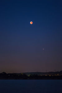 Scenic view of sea against clear sky at night