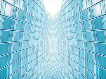 Low angle view of glass building against sky