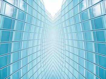 Low angle view of glass building against sky