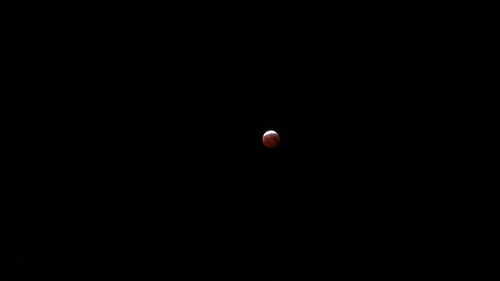 Low angle view of moon against black background