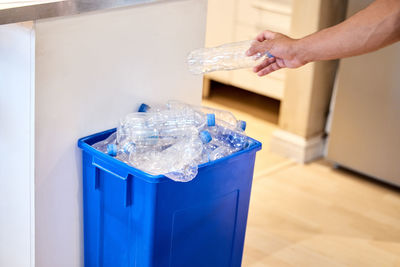 Cropped hand of person cleaning bottle