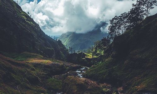 Scenic view of mountains against cloudy sky