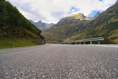 Surface level of empty road against mountain range